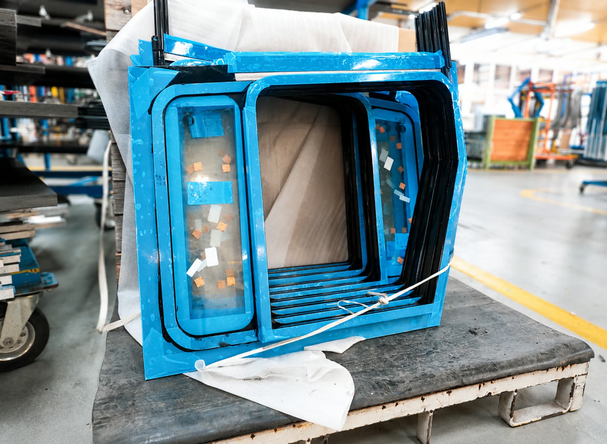 A finished KÖNIG window assembly wrapped and strapped for delivery
